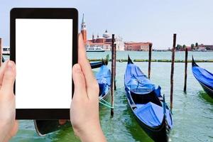 tourist photographs gondolas on San Marco Canal photo