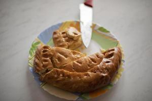 Pie in kitchen. Flour cake on table. Treat to tea. Delicious food. photo