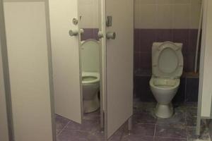 Toilet cabin. Toilet in shopping center. Restroom in office. Dirty room. photo