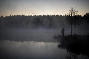 Lake in early morning. Lake and forest in fog. Details of nature in summer. photo