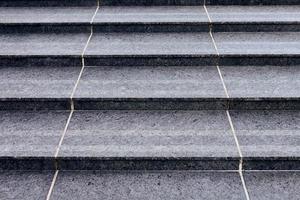 Grey stone steps in modern style, large staircase with stone-like grey texture, wide granite ladder photo