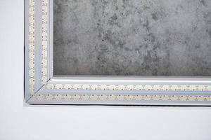 Strip LED light with square aluminum profile on stretch ceiling, close up. Home renovation concept photo