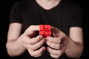 Red gift box in hand on St. Valentine day photo