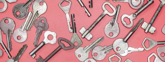 Keys set on pink background. Door lock keys and safes for proper photo