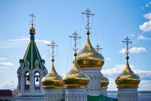 Domes of orthodox church. Golden crosses of russian church. Sacred place for parishioners and prayers for salvation of soul. photo