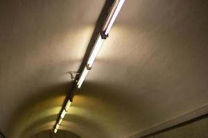 Lamps on ceiling of tunnel. Details of interior of metro. photo
