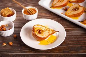 Honey or maple syrup roast pears with walnuts. Vegetarian diet health delicious dessert. photo