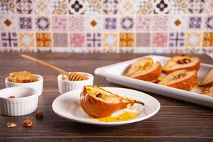 Honey or maple syrup roast pears with walnuts. Vegetarian diet health delicious dessert. photo