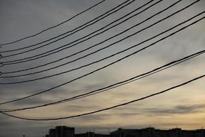 Electrical wires on pole. Many wires against sky. photo