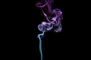 Multicolored smoke for aromatherapy relaxation on black background, beautiful swirled puffs of smoke photo