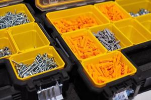 Storage case with screws, nuts, bolts, nails and other small tools for handyman, close up photo