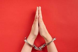 Praying hands in handcuffs photo