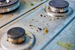 Dirty gas stove with food leftovers and crumbs photo