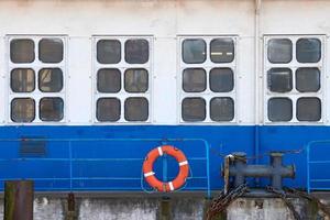 Hull of vintage ocean liner, fragment of moored ship in port photo