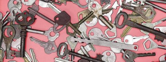 Keys set on pink background. Door lock keys and safes for proper photo