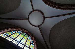 Stained glass window in old cathedral or church. Beautiful colored glass window. Day lighting photo