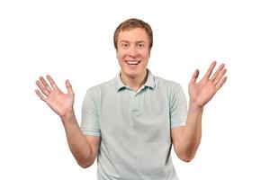 Funny smiling man in T-shirt showing palms of hands, unexpected surprise gesture, white background photo