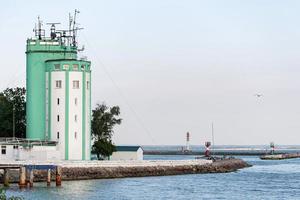 Pilot tower in seaport. Sea traffic control and ships management. Tower for logistic, monitoring wind speed and direction of flow. photo