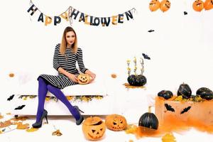 young woman with black pumping in Halloween decoration photo