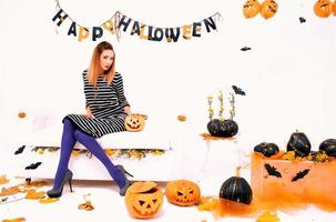 young woman with black pumping in Halloween decoration photo