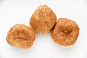 Delicious buns with jam on a white background. Sweet doughnuts with stuffing close-up. photo