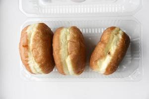 Delicious buns with jam on a white background. Sweet doughnuts with stuffing close-up. photo