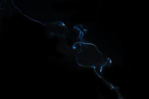 White smoke on black background for layer overlay effect. A realistic smoke or fog effect for photo and video manipulation effect and mystery design theme