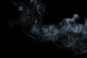 White smoke on black background for layer overlay effect. A realistic smoke or fog effect for photo and video manipulation effect and mystery design theme