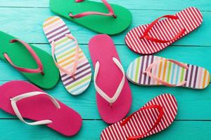 flip flops on blue wooden floor background. Top view and copy space. Summer fun weekend photo