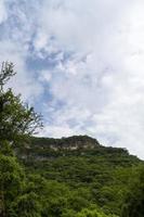 trees framing mountains, huentitan canyon in guadalajara, mountains and trees, green vegetation and sky with clouds, mexico photo