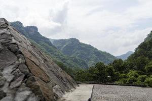 stone pyramid and stone floor in the background vegetation mountains, clouds and sky, barranca de huentitan, guadalajara photo