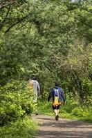 two young men and friends descending in the ravine, vegetation and trees, huentitan ravine guadalajara, mexico photo