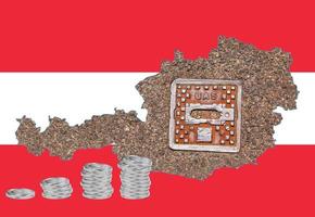 Outline map of Austria with the image of the national flag. Manhole cover of the gas pipeline system inside the map. Stacks of Euro coins. Collage. Energy crisis. photo
