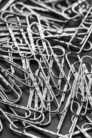 Silver Paper clips scattered as textured background photo