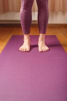 Legs and hands of a woman on a yoga mat practicing asanas photo