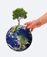 The globe in hands of the child,isolated on a white photo