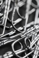 Silver Paper clips scattered as textured background photo