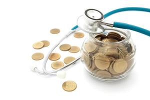 stethoscope with coins in the savings, financial concept photo