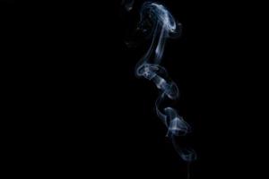 White smoke on black background for layer overlay effect. A realistic smoke or fog effect for photo and video manipulation effect and mystery design theme