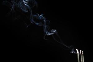 White smoke on black background for layer overlay effect. A realistic smoke or fog effect for photo and video manipulation effect and mystery design theme