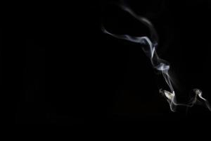 White smoke on black background for layer overlay effect. A realistic smoke or fog effect for photo and video manipulation effect and mystery design theme