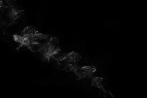 White smoke on black background for layer overlay effect. A realistic smoke or fog effect for photo and video manipulation effect and mystery design theme