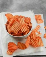 Cheese flavored cassava chips served in a bowl with a white theme photo