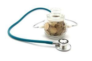 stethoscope with coins in the savings, financial concept photo