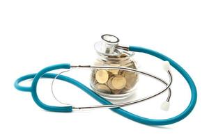 stethoscope with coins in the savings, financial concept photo