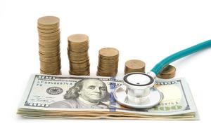 Stack of coins and money and stethoscope photo