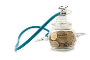 stethoscope with coins in the savings, financial concept photo