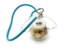 stethoscope with coins in the savings, financial concept photo