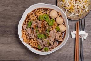 Instant Noodles, Noodles, Nam Tok Moo.in a white bowl is Thai food photo