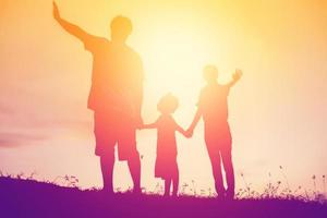 silhouette of a happy family and happy time sunset photo